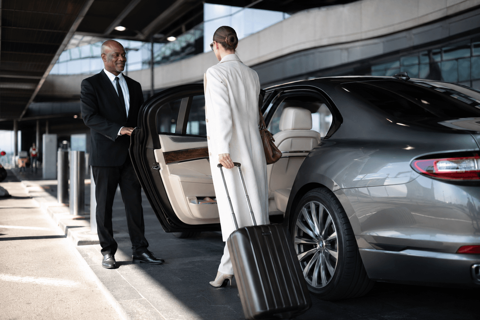 Executive chauffeur opening a luxury car door for a passenger
